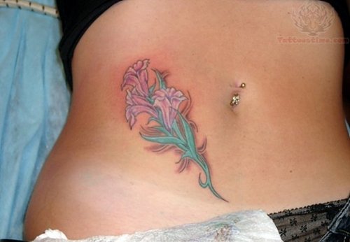 Belly Piercing And Hip Flower Tattoo